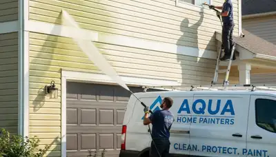 Vinyl siding pressure cleaning in Tacoma, WA for moss and grime removal on a home exterior